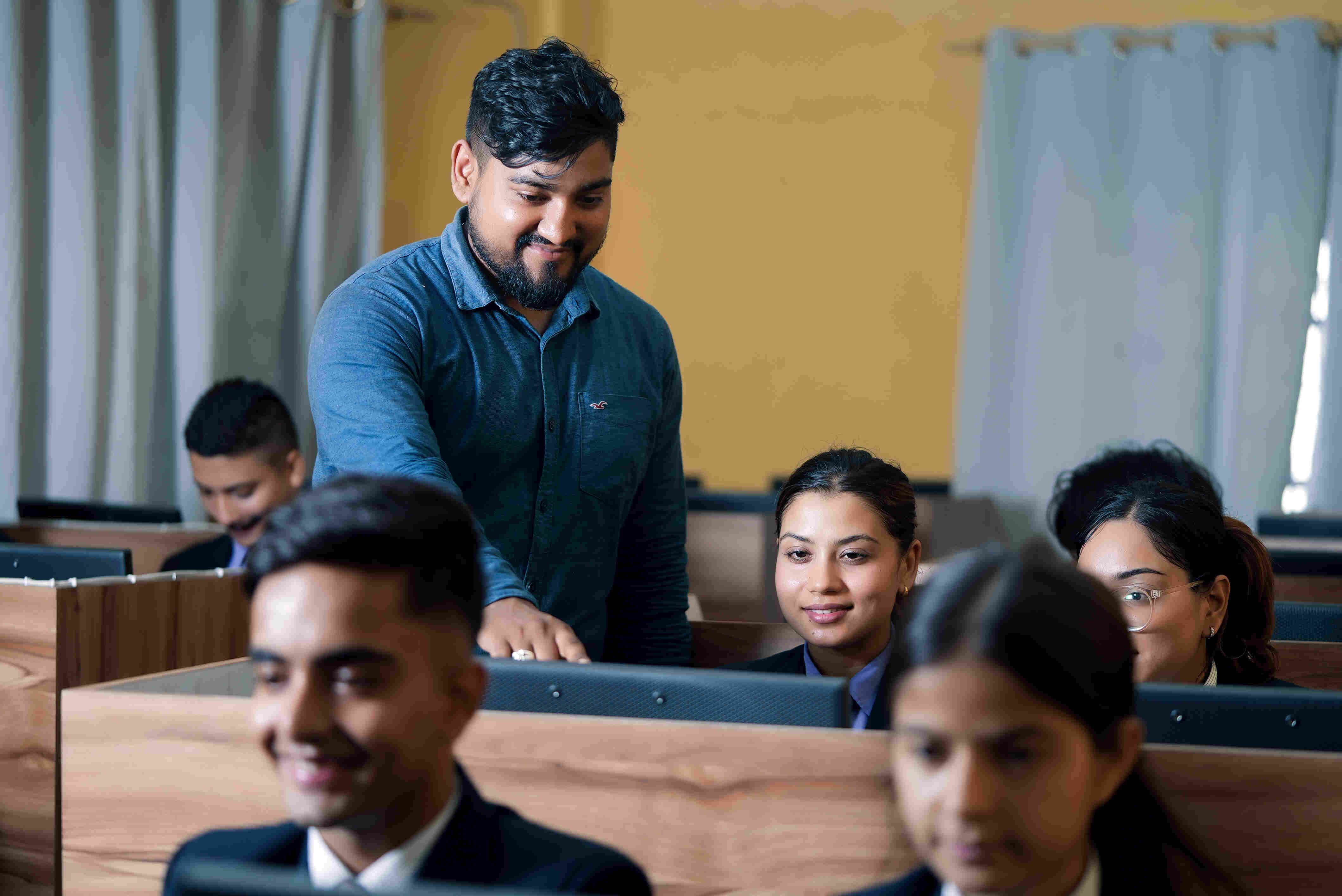 People collaborating on laptops, symbolizing modern IT work and learning
